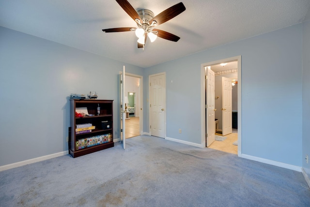 bedroom with light carpet, a textured ceiling, and ceiling fan