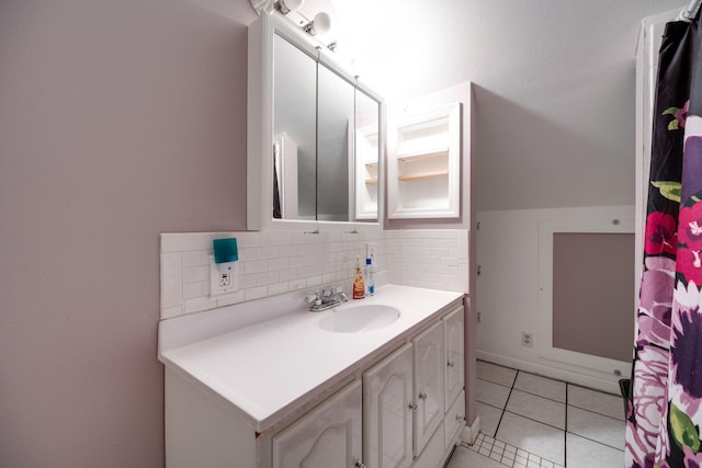 bathroom with vanity, backsplash, and tile patterned flooring