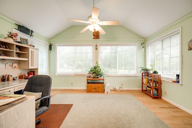 home office with ceiling fan, vaulted ceiling, and plenty of natural light