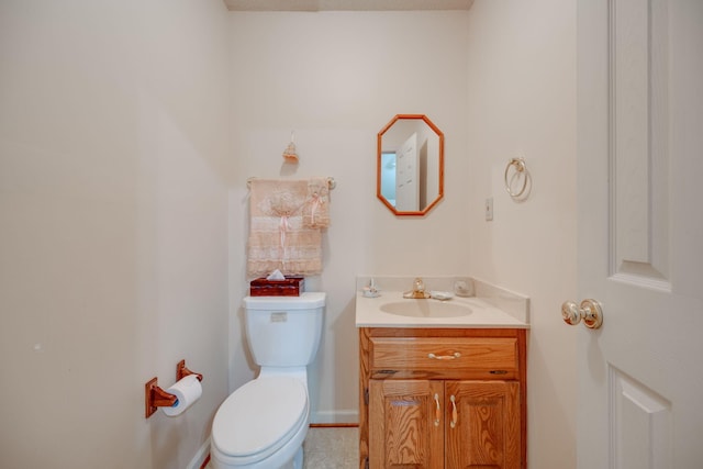 bathroom with vanity, toilet, and tile patterned floors