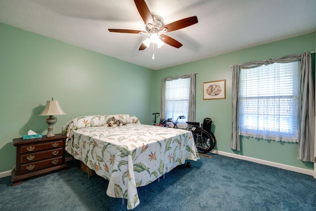 carpeted bedroom featuring a textured ceiling and ceiling fan