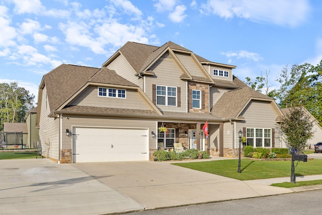 craftsman inspired home with a front yard and a garage