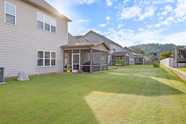 view of yard featuring a sunroom and central air condition unit