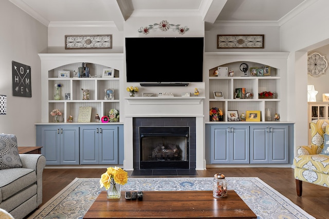 living room with ornamental molding, a tile fireplace, and dark hardwood / wood-style floors