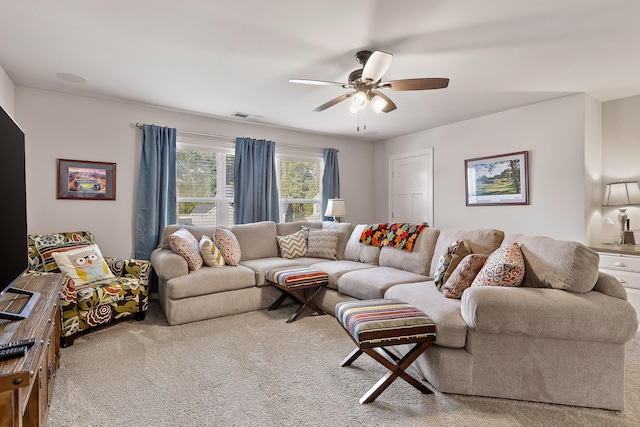 carpeted living room featuring ceiling fan