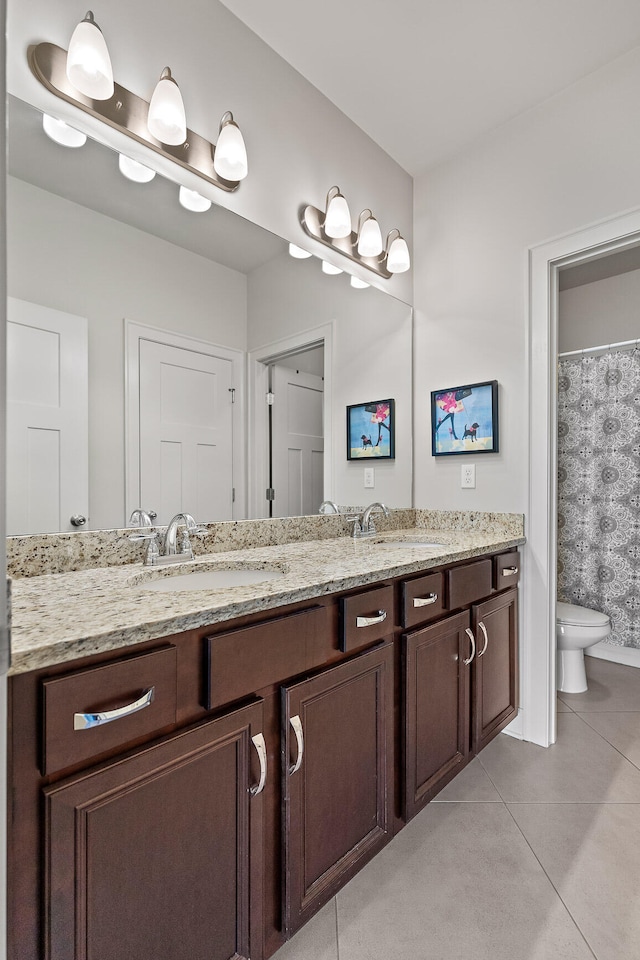 bathroom with tile patterned floors, vanity, and toilet