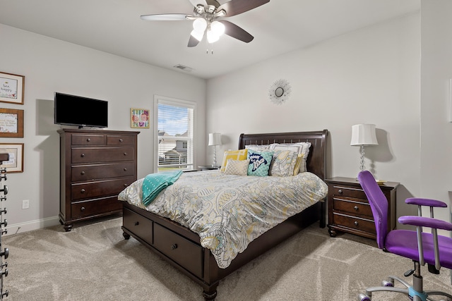 bedroom with ceiling fan and light carpet