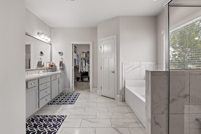 bathroom featuring vanity and a washtub