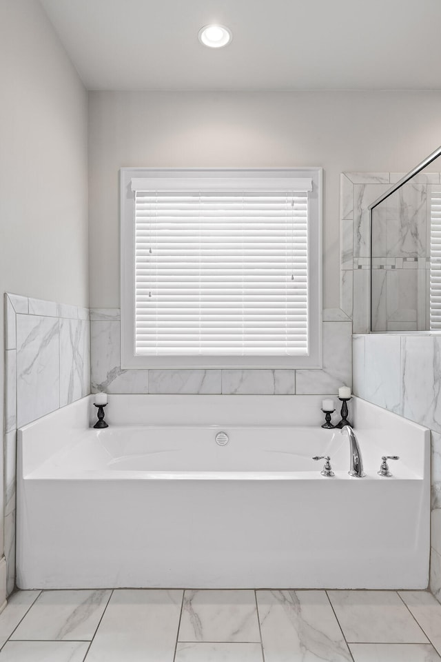 bathroom featuring separate shower and tub