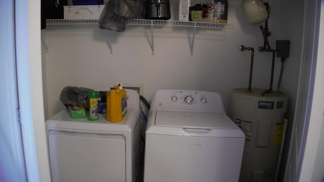 laundry area with separate washer and dryer and electric water heater