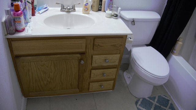 bathroom featuring curtained shower, vanity, toilet, and tile patterned floors