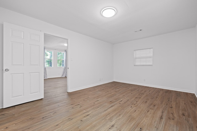 unfurnished room featuring wood-type flooring