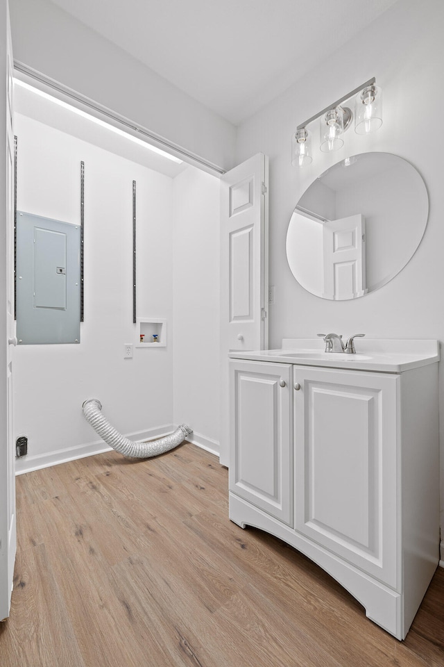 bathroom with vanity, hardwood / wood-style floors, and electric panel