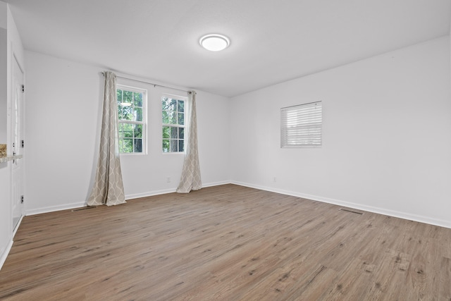 unfurnished room with light hardwood / wood-style floors