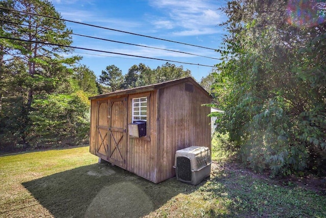 view of outbuilding with a yard