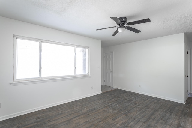 spare room featuring a textured ceiling, a healthy amount of sunlight, dark hardwood / wood-style flooring, and ceiling fan