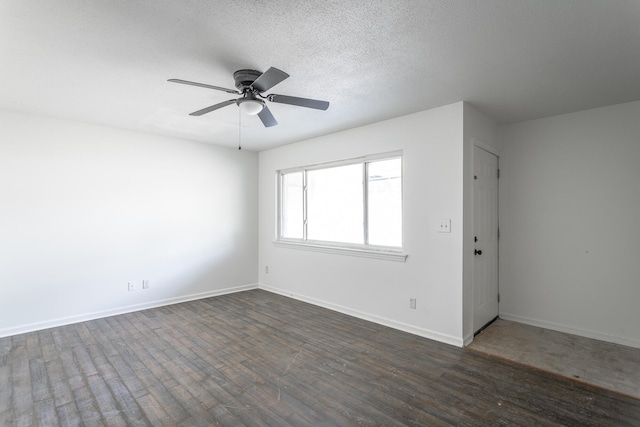 unfurnished room featuring ceiling fan, a textured ceiling, and dark wood-type flooring