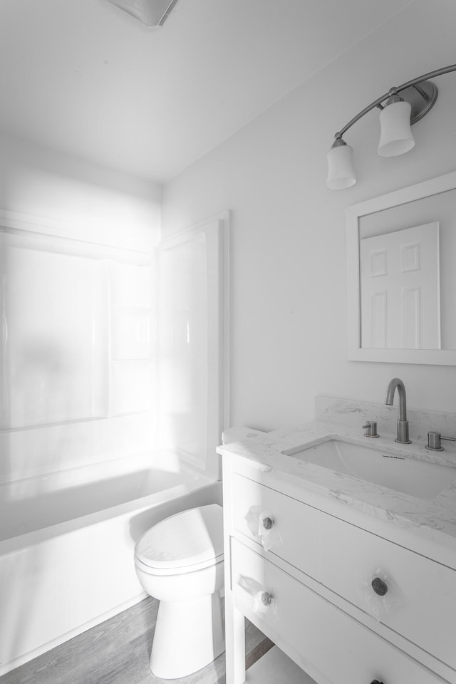 full bathroom with shower / bathing tub combination, vanity, toilet, and hardwood / wood-style flooring