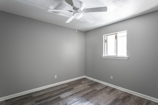 spare room featuring a textured ceiling, ceiling fan, and dark wood-type flooring