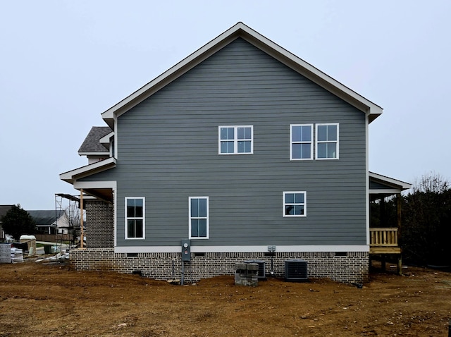 view of side of property with central air condition unit