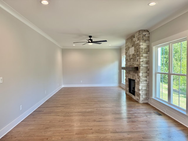 283 Quartz Dr Unit 22, Chickamauga, GA 30707 - unfurnished living room featuring plenty of natural light, a ceiling fan, a stone fireplace, recessed lighting, and crown molding