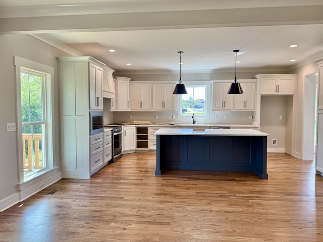 283 Quartz Dr Unit 22, Chickamauga, GA 30707 - kitchen featuring electric range, plenty of natural light, crown molding, a kitchen island, and white cabinets