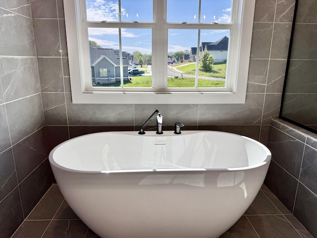 283 Quartz Dr Unit 22, Chickamauga, GA 30707 - bathroom with tile walls, plenty of natural light, a freestanding tub, and tile patterned floors