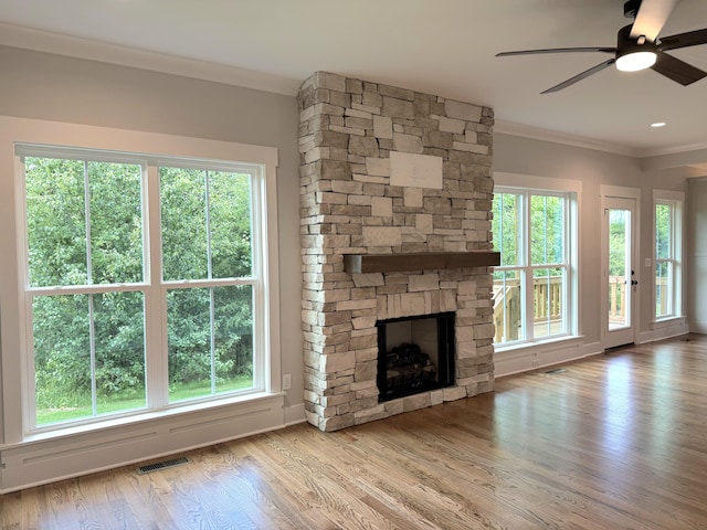 283 Quartz Dr Unit 22, Chickamauga, GA 30707 - unfurnished living room with ornamental molding, a stone fireplace, ceiling fan, and wood finished floors