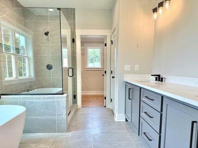 283 Quartz Dr Unit 22, Chickamauga, GA 30707 - full bathroom featuring a freestanding tub, vanity, a shower stall, tile patterned flooring, and baseboards