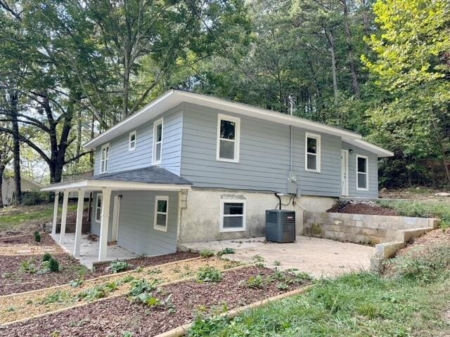 rear view of house featuring central AC unit and a patio