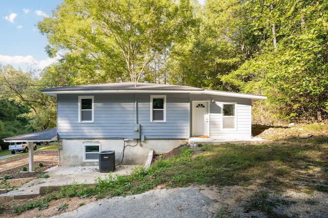 rear view of property featuring a patio and central AC