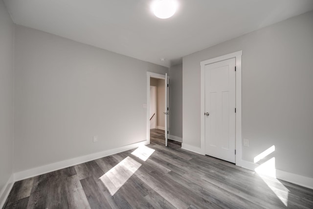 unfurnished bedroom featuring hardwood / wood-style flooring and a closet