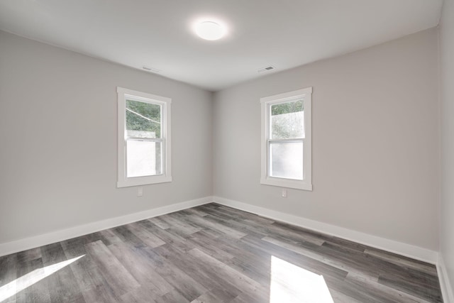 unfurnished room featuring hardwood / wood-style floors and a healthy amount of sunlight