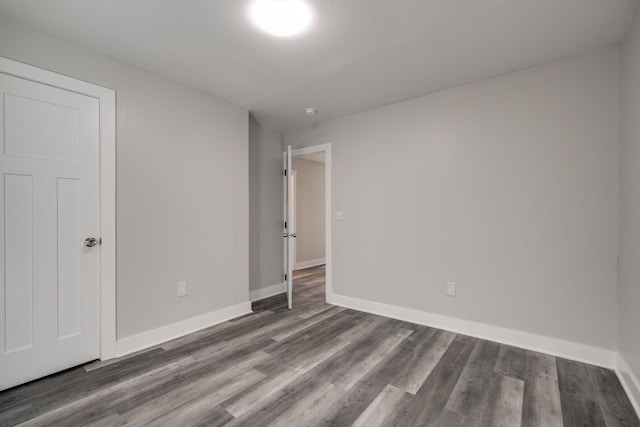 unfurnished bedroom with dark hardwood / wood-style flooring