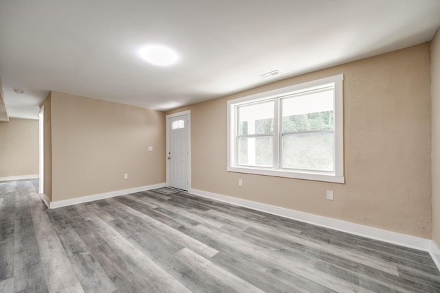 unfurnished room with hardwood / wood-style floors