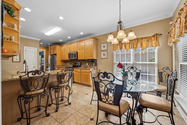 dining area featuring ornamental molding, a chandelier, light tile patterned floors, and sink