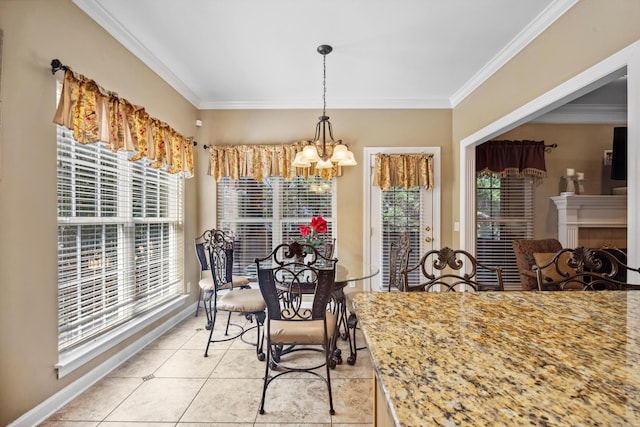 dining space featuring ornamental molding, light tile patterned flooring, and a healthy amount of sunlight