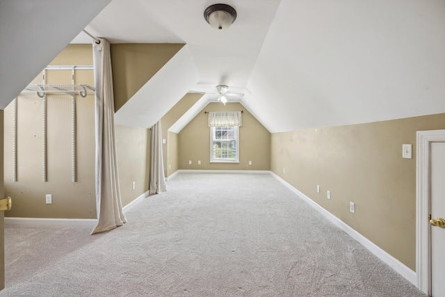 bonus room with ceiling fan, light colored carpet, and vaulted ceiling