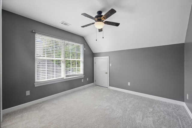 additional living space with lofted ceiling, ceiling fan, and light colored carpet