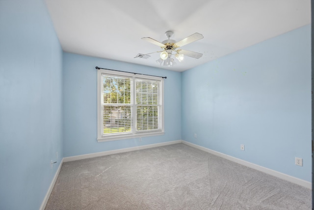 empty room featuring carpet flooring and ceiling fan