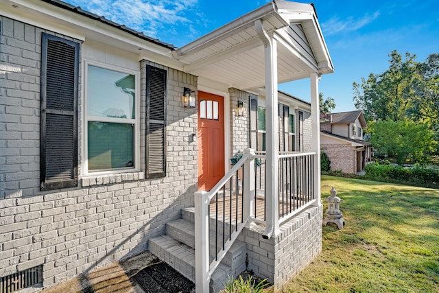 doorway to property with a yard