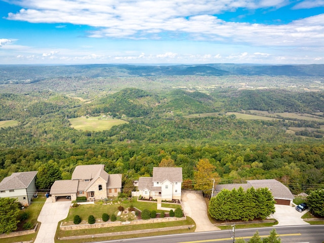 birds eye view of property featuring a wooded view and a residential view