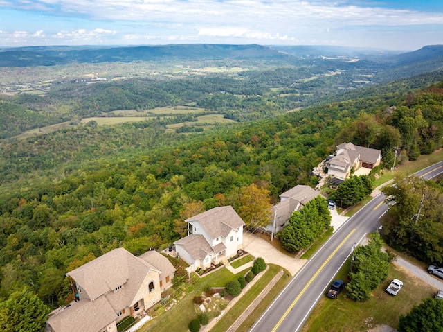 aerial view featuring a wooded view and a residential view