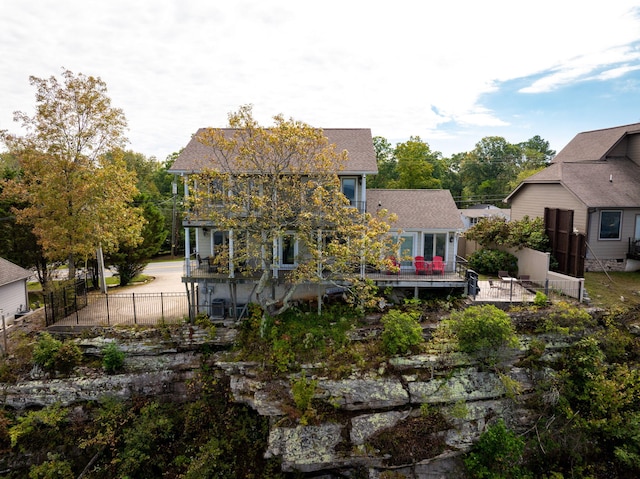 rear view of house with fence