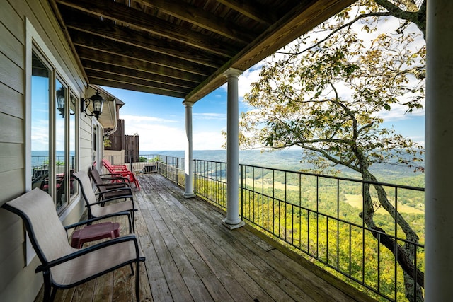 wooden terrace with a water view