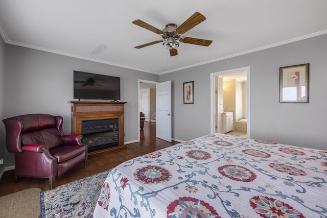 bedroom featuring ornamental molding, dark wood-type flooring, a glass covered fireplace, and baseboards