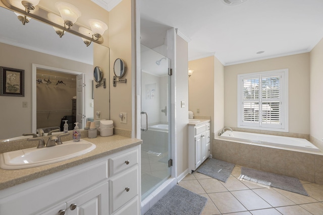 bathroom featuring a spacious closet, tile patterned floors, vanity, and crown molding