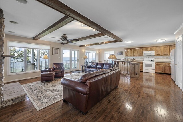 living room with dark wood-type flooring and beamed ceiling