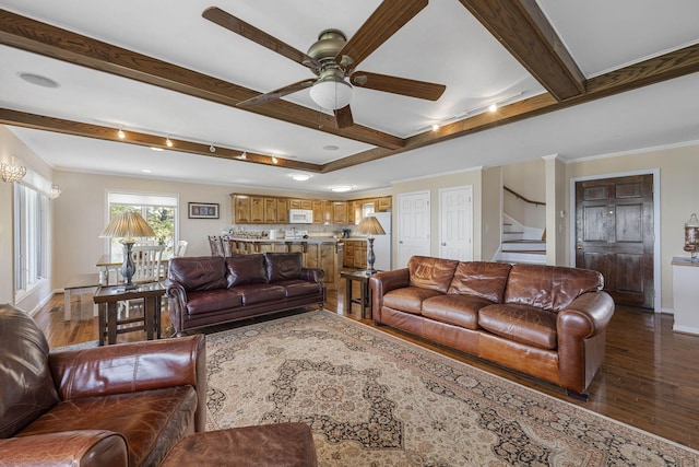 living area featuring stairs, baseboards, beamed ceiling, and wood finished floors