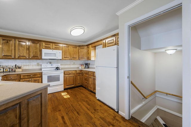 kitchen with white appliances, light countertops, ornamental molding, brown cabinets, and tasteful backsplash